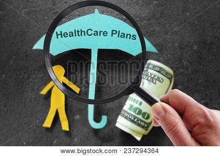 Person With Magnifying Glass And Healthcare Plans Umbrella With Cash