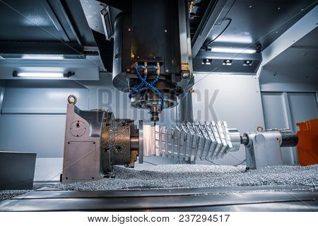 Metalworking CNC milling machine. Cutting metal modern processing technology. Small depth of field. Warning - authentic shooting in challenging conditions. A little bit grain and maybe blurred.