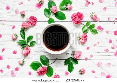 Flowers Composition. Cup Of Coffee Or Black Tea In Frame Made Of Fresh Rose Flowers On White Wooden 