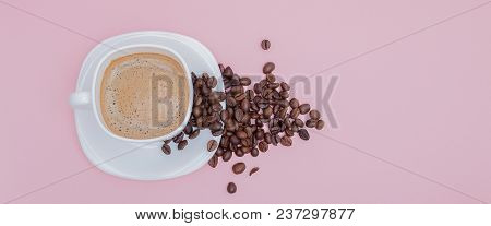 Grains Of Roasted Coffee Scattered From A Cup On A Pink Background, Copy Space. Top View.