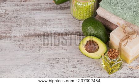 Natural Cosmetic Oil And Natural Handmade Soap With Avocado On White Rustic Wooden Background. Healt