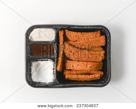 Biscuit, Dried Bread In Plactic Case With Sauce On White Background Isolated