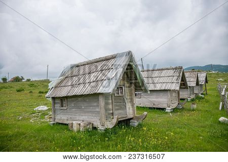 High In The Mountains Are Small Wooden Houses For Overnight Tourists.