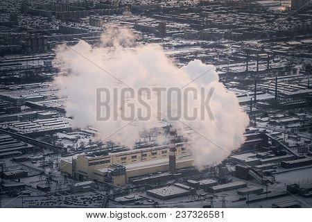 Air Pollution By Smoke Coming Out Of Two Factory Chimneys. Industrial Zone In The City. Aerial View.