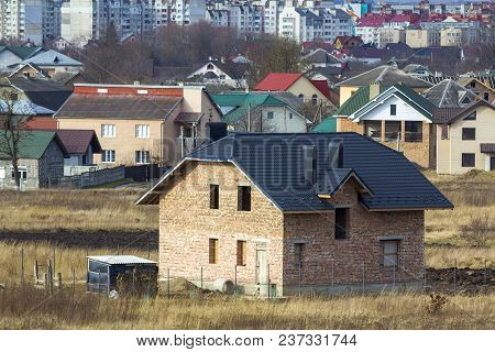 Brand New Spacious Brick Two Story Residential House With Tiling Roof And Windows Openings In Suburb