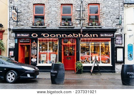 Kenmare, Ireland - November 10, 2017: Pub Entrance In Street With Picturesque And Colorful Houses In