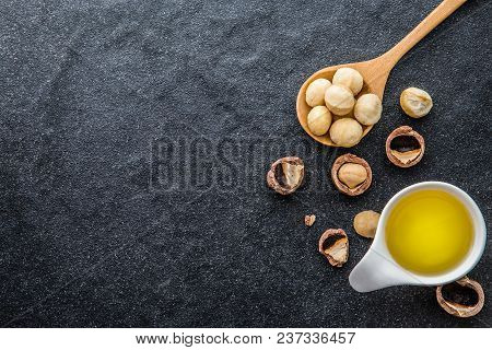Macadamia Nut Oil And Peeled Macadamia Nut  On Black Stone , ﻿use For Healthy Skin And Hair And Natu
