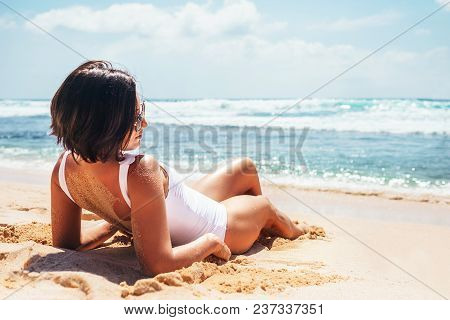 Woamn Takes A Sun Bath On Tropical Beach