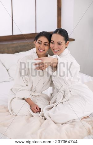 Beautiful Memories. Nice Lesbian Couple Sitting Together While Taking Selfies