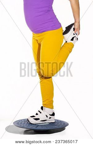 Little Caucasian Girl In On One Leg Position Staing On Balance Board. Photo On White Background