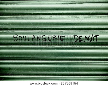 A Bakery Metal Shutter Door, With A Text. Boulangerie De Nuit (bakery At Night)