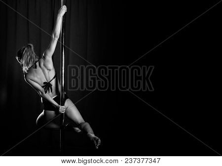 Young Sexy Woman Exercise Pole Dance On Dark Background, Beautiful Girl In Club, Sporty Elegant Woma