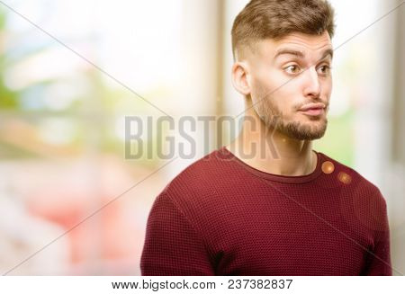 Handsome young man making funny face fooling