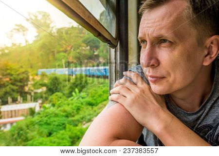 Man Travel By Train From Nuwara Eliya To Kandy Among Tea Plantations In The Highlands Of Sri Lanka