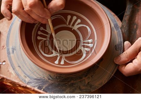 Scary Face Alike Handmade Potter Mug Surrounded With Plain Cups On A Wooden Shelf, Close-up, Selecti