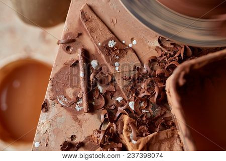 Red Clay Shavings On The Worktop Background, Top View, Close-up, Shallow Depth Of Field. Pottery Wor