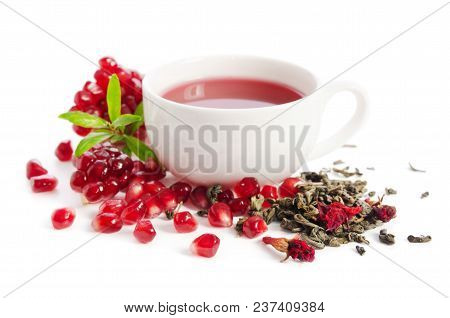 Parts Of A Pomegranate With Pomegranate Seeds And Leaves, Flowers, Dry Tea Of Carcade And Full Cup O