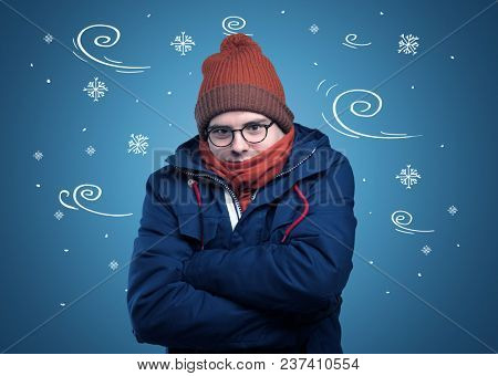 Young hipster frozen boy with doodled snowflakes and windy concept