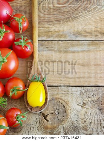 Fresh Red And Yellow Tomatoes On Wooden Background.