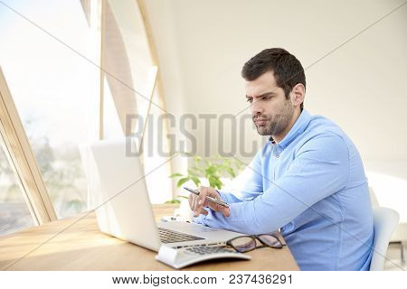 Young Businessman Working On Laptop