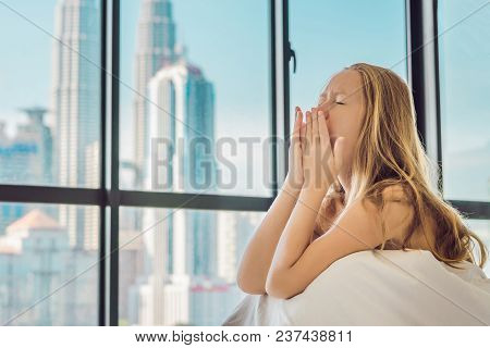 Woman Wakes Up In The Morning In An Apartment In The Downtown Area With A View Of The Skyscrapers. L