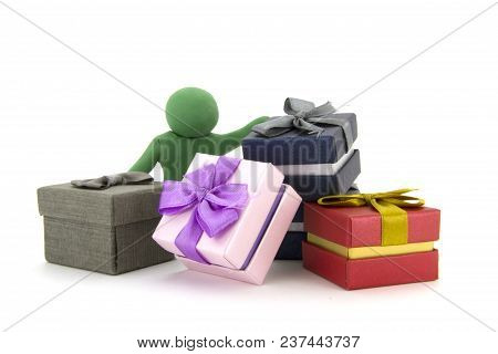 Green Plasticine Character And Gift Boxes On White Background. Present Boxes. Holidays Concept.
