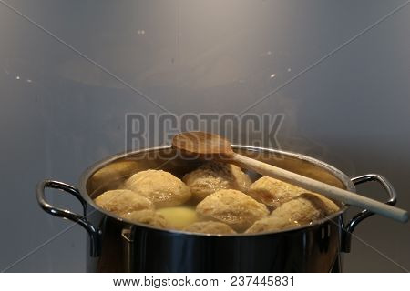 Pot With Dumplings And Wooden Spoon. Copy Space.