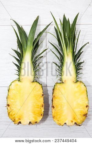 Looking Down From Above Onto A Pineapple That Has Been Sliced Into Two Halves Revealing The Inside A