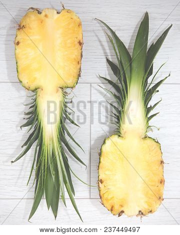 Looking Down From Above Onto A Pineapple That Has Been Sliced Into Two Halves Revealing The Inside A