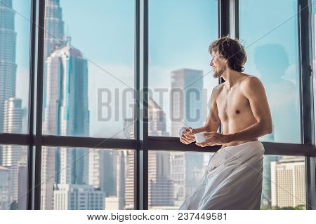 Man Wakes Up In The Morning In An Apartment In The Downtown Area With A View Of The Skyscrapers And 