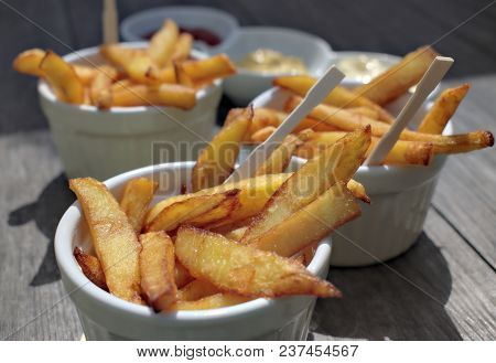 Tasty Food, Nutrition, Kitchen And Culinary Concept: Homemade Fries In Bowls For Snacks On Wooden Ba