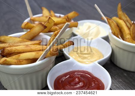 Tasty Food, Nutrition, Kitchen And Culinary Concept: Homemade Fries In Bowls For Snacks On Wooden Ba