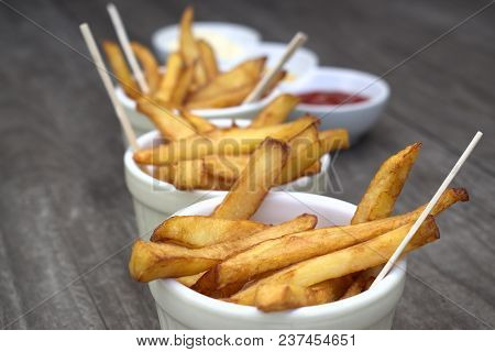 Tasty Food, Nutrition, Kitchen And Culinary Concept: Homemade Fries In Bowls For Snacks On Wooden Ba