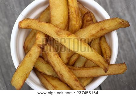 Tasty Food, Nutrition, Kitchen And Culinary Concept: Homemade Fries In Bowl For Snacks On Wooden Bac