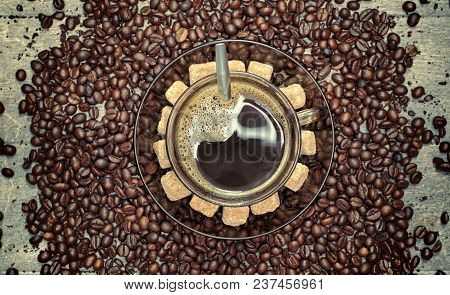 Cup Of Coffee With Brown Sugar On Wooden Table.