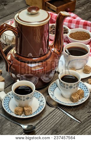 Caffeine Design Concept-old Kettle For Coffee, Coffee Cups On A Wooden Background With A White Red C