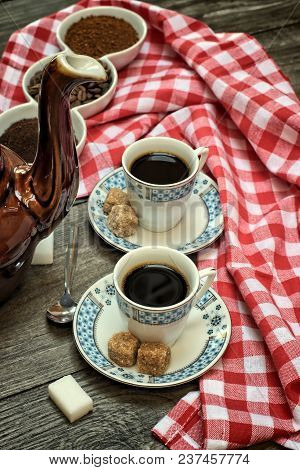 Caffeine Design Concept-old Kettle For Coffee, Coffee Cups On A Wooden Background With A White Red C