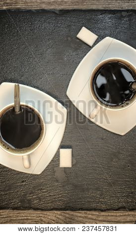 Drinks, Drinking, Energy And Caffeine Concept-two Cups Of Coffee On A Dark Slate Stand And Wooden Ba