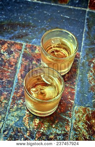 Alcohol,taste And Drink Concep-two Glasses Of Whisky On A Old Stone Background.