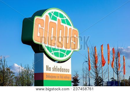 Ostrava, Czech Republic - April 13, 2018: Logo Of The Globus Hypermarket Chain And Flags In Wind In 