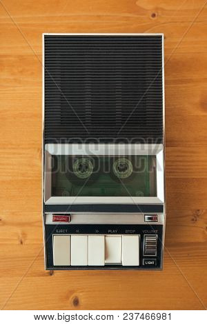 Audio Cassette Tape Rolling In Vintage Player On The Desk, Top View. Police Interrogation Sound Reco