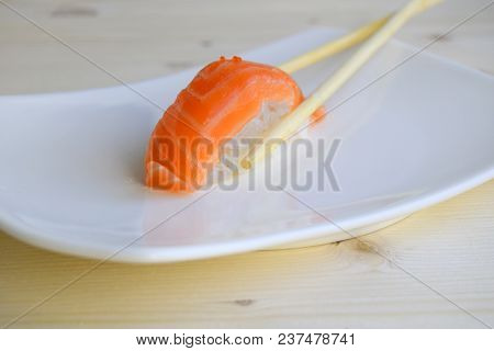 Sushi, Nigiri, Sake A Dish Of The Traditional Japanese Cuisine Cooked From Rice And A Salmon. Wooden