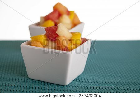 Fruit Salad Mix Of Melon, Banana, Watermelon, Orange And Pineapple In A Small Porcelain Bowl, Breakf