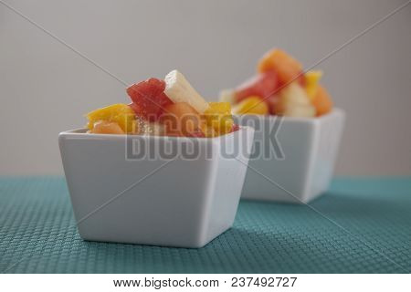 Fruit Salad Mix Of Melon, Banana, Watermelon, Orange And Pineapple In A Small Porcelain Bowl, Breakf