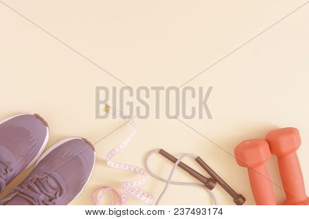 Fitness Background With Space For Text. Toned Photo. Sneakers, Dumbbells, Skipping Rope And Tape Mea