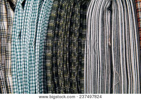 Different Types Of Fabrics Are Folded Neatly In A Row