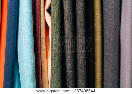 Different Types Of Fabrics Are Folded Neatly In A Row