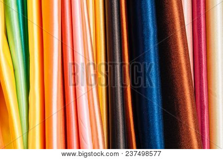 Different Types Of Fabrics Are Folded Neatly In A Row