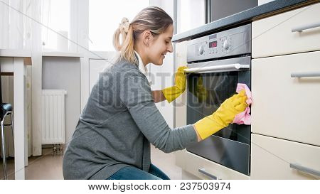 Smiling Woman Doung Housework And Cleaning Kitchen
