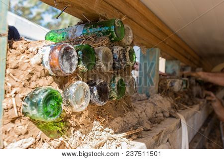 Bottle Wall Construction Process. Eco Building, Straw Bale Home With Recycling Material